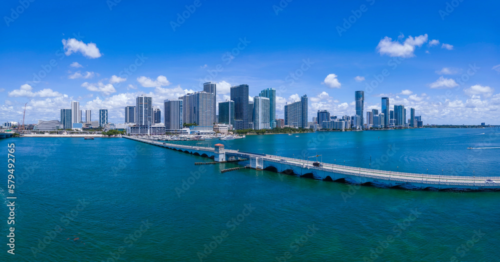 Venetian Causeway Bridge at the Intracoastal Waterway, Miami Beach, Florida. Panorama of a long bridge heading to the coastline skyscrapers in NE 15th Street against the cloudy sky background.