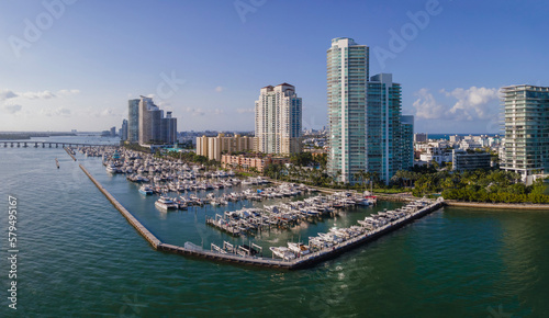 Boat harbor at Meloy Channel with coastline skyscrapers at Miami Beach, Florida. Aerial view of a harbor near the bridge in an intracoastal area.
