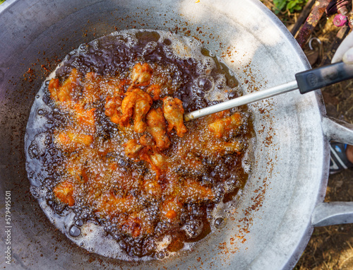 Deep fried chicken wings in wok pan
