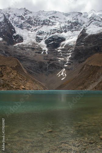 Laguna de Humantay, turquoise waters and view of the Salcantay mountain in Peru, on a grey day. 