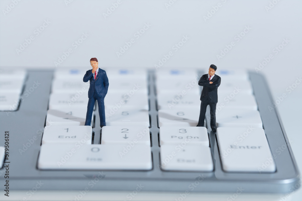 business people stand thoughtfully at a keyboard. Concept: business plan business people stand thoughtfully at a keyboard. Concept: business plan