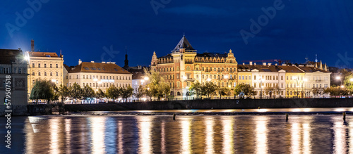 Nighttime panoramic view of Smetana's embankment and the Vltava River in Prague, Czech Republic
