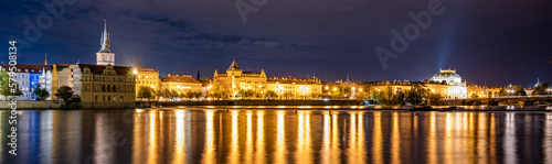 Night panoramic view of the Vltava River, Smetana Embankment, and the National Theatre in Prague, Czech Republic