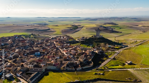 Aerial drone view of the town of Tiedra in the province of Valladolid in Spain, with surrounding agricultural fields. photo