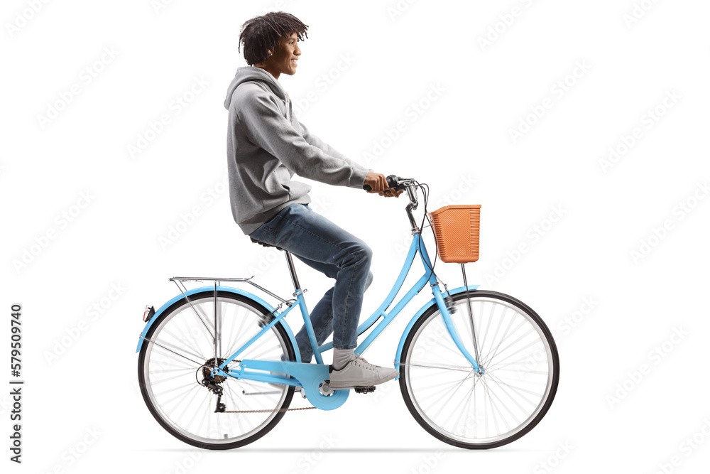 Full length profile shot of a casual young african american man riding a bicycle Full length profile shot of a casual young african american man riding a bicycle