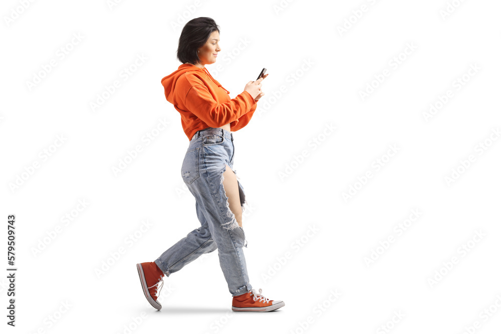 Full length profile shot of a gen z female using a smartphone and walking - obrazy, fototapety, plakaty 
