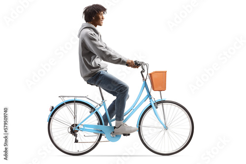 Full length profile shot of a casual young african american man riding a bicycle