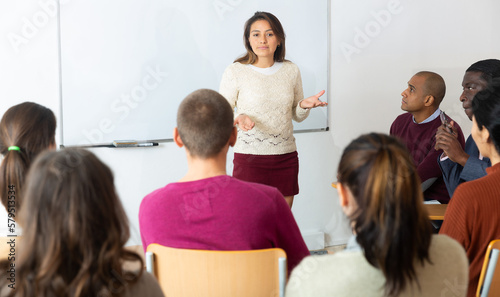 Teacher standing in front of whiteboard and teaching lesson
