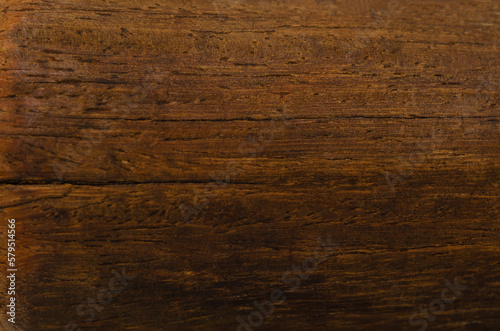 Old grunge wooden cutting kitchen desk board as background, copy space available. Dark scratched grunge cutting board