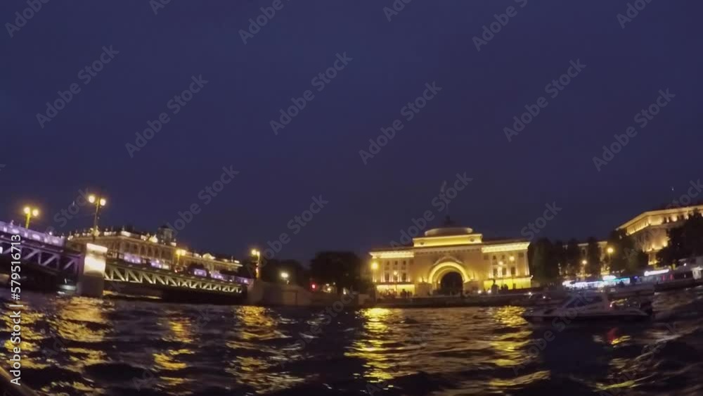 Sailing on a boat in a city river at night in summer. Passenger touristic ship. Sailing on a boat in a city river at night in summer. Passenger touristic ship.