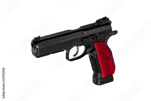 A modern black semi-automatic pistol with a red grip. A short-barreled weapon for self-defense and sport. Isolate on a white back.