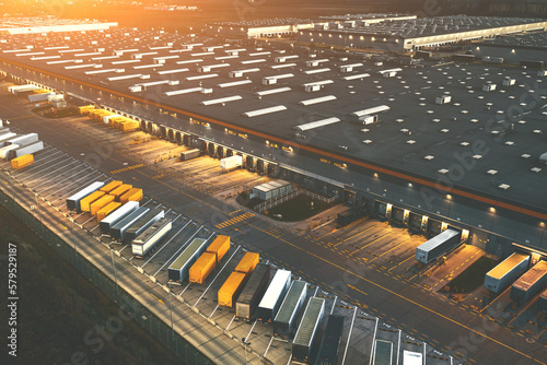 Aerial view of semi trailers with cargo trailers parked near logistics warehouses