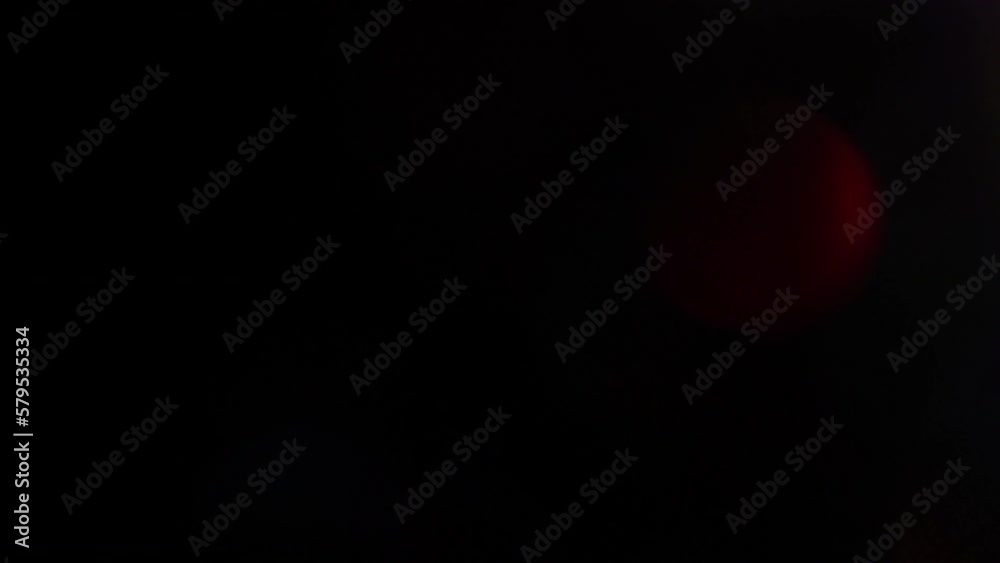 Abstract Motion Of Defocused Bokeh. Bokeh glow overlay. Defocused neon red blue green shiny flecks motion on dark black background. Real Light Leaks effect. 4K background animation or transition.