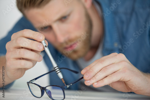 the man holds his glasses in his hands