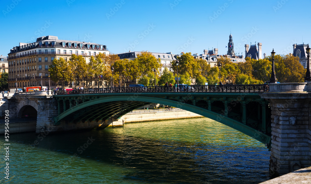 Pont Notre-Dame - old arch bridge across Seine river in Paris on sunny autumn day, France..