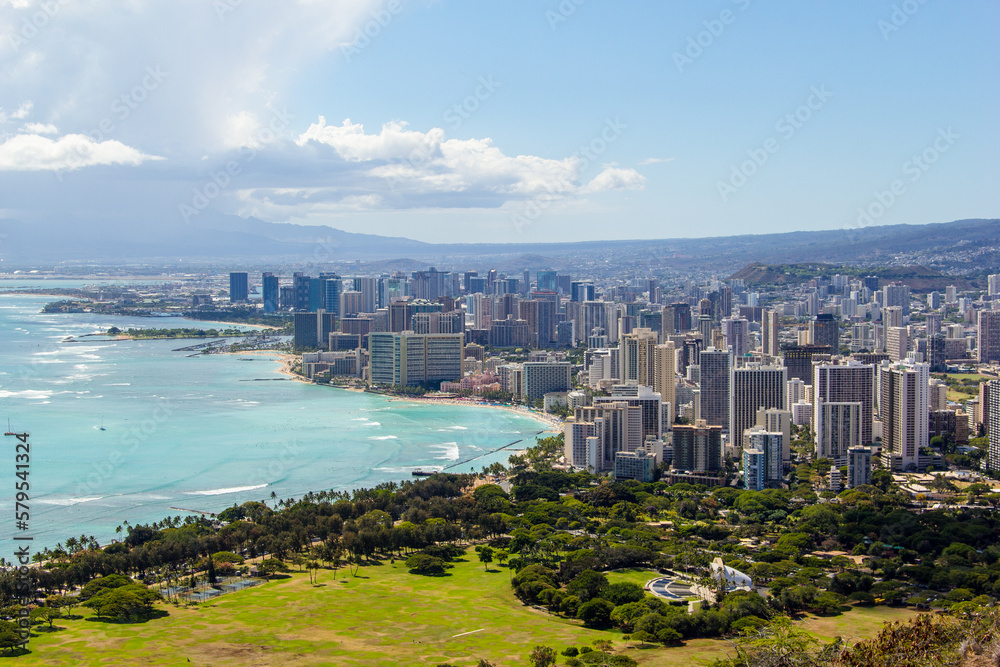 View of the city of Honolulu from above at the top of Diamond Head Crater, in Oahu, Hawaii. Sail boats and buildings.