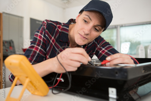 focused woman during tv and repair and maintenance