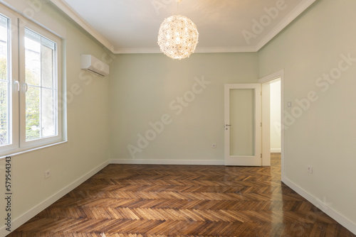 Interior of an empty apartment with brown wooden parquet © rilueda