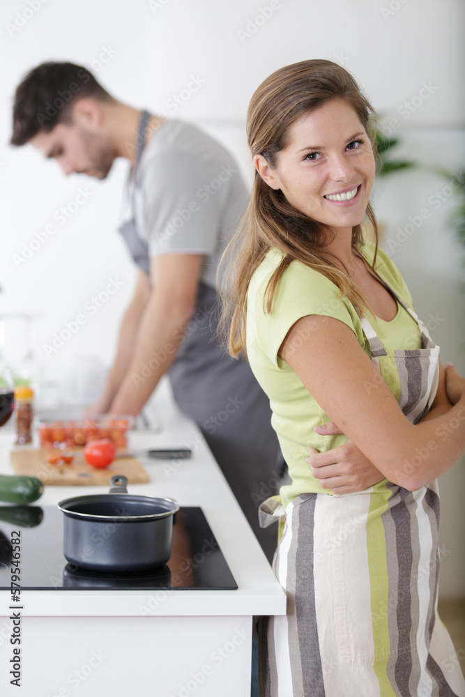 portrait of a happy young woman in the kitchen portrait of a happy young woman in the kitchen