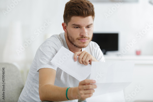 man reading letter and upset bad news mail