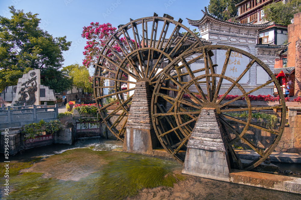 August 7, 2021, Lijiang, China. The two Giant Water Wheels at Lijiang Old Town, is the most ancient irrigation tool in China. landmark and popular spot for tourists attractions. August 7, 2021, Lijiang, China. The two Giant Water Wheels at Lijiang Old Town, is the most ancient irrigation tool in China. landmark and popular spot for tourists attractions.