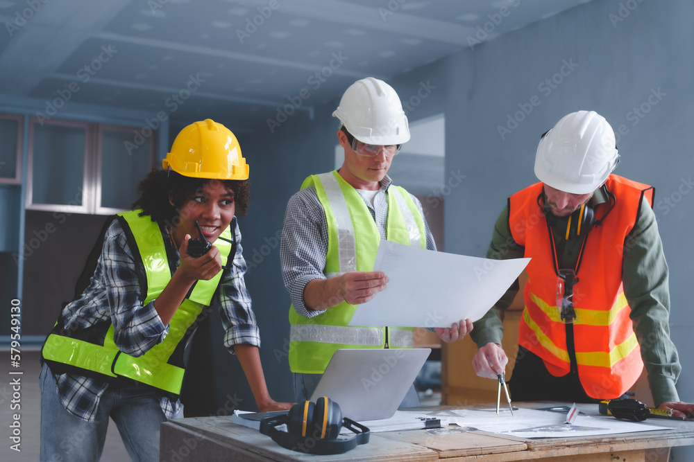 Fototapeta premium Group of multi ethnic engineer construction site worker meeting at workplace, Architects working together at construction site to remodeling home or building.