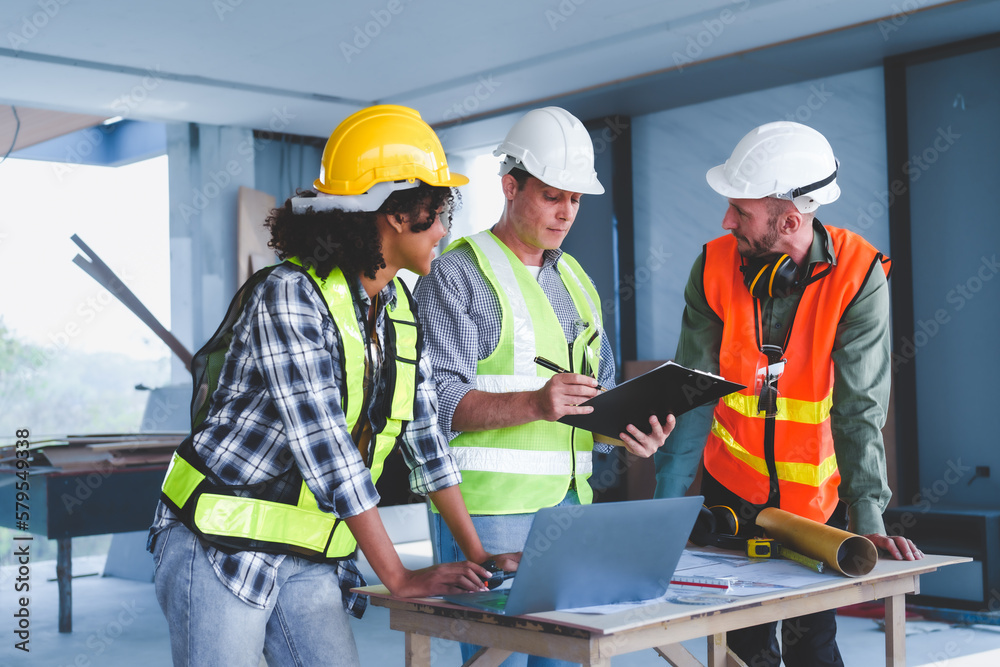 Group of multi ethnic engineer construction site worker meeting at workplace, Architects working together at construction site to remodeling home or building. Group of multi ethnic engineer construction site worker meeting at workplace, Architects working together at construction site to remodeling home or building.