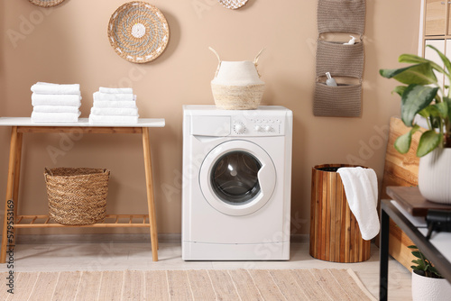Stylish laundry room with modern washing machine. Interior design