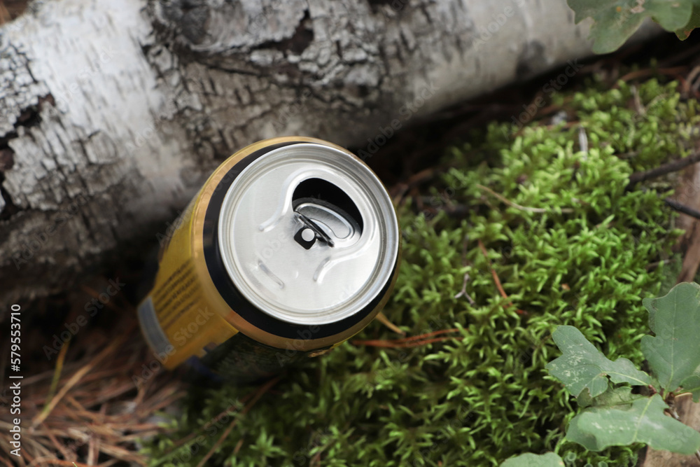 Used aluminum can on ground outdoors, closeup. Recycling problem Used aluminum can on ground outdoors, closeup. Recycling problem