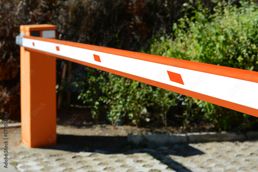 Modern road barrier outdoors on sunny day, closeup Modern road barrier outdoors on sunny day, closeup