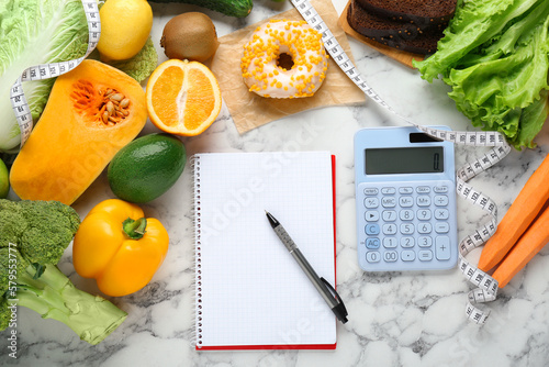 Food products, notebook with calculator on white marble table, flat lay. Weight loss and calorie counting concept photo