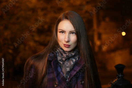 beautiful girl, in the evening at night in the city on the street, cool, cold, with a round natural face, fashion, autumn © Velychko
