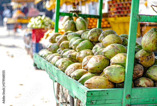Fresh coconuts pile up on a street vendor cart in Sarnath, India.