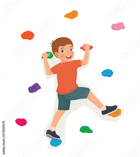 Cute little boy climbing wall with colorful rock