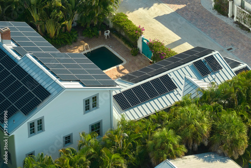Aerial view of big expensive american building roof with solar photovoltaic panels for producing clean ecological electric energy. Investing in renewable electricity for retirement income concept © bilanol
