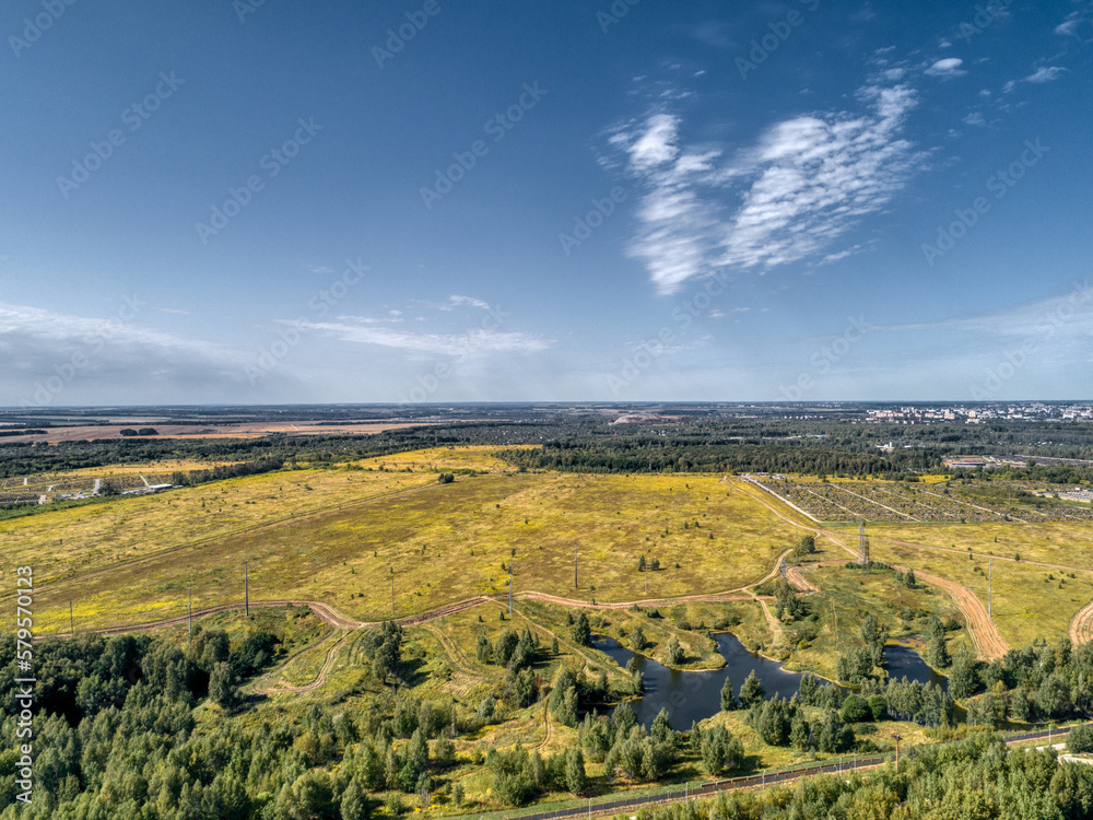 Flat landscape of fields and forests, aerial view. Sunny summer day