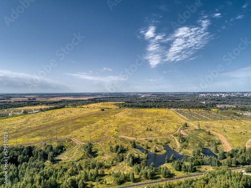 Flat landscape of fields and forests, aerial view. Sunny summer day