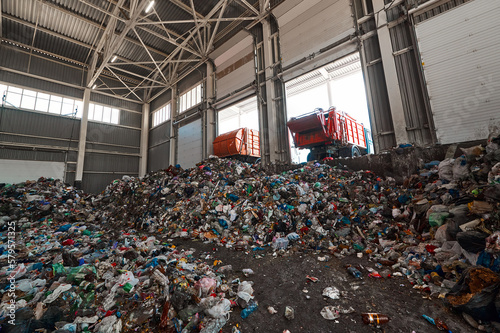 Bild auf Leinwand Garbage truck unloads household waste in the receiving chamber of a waste sortin