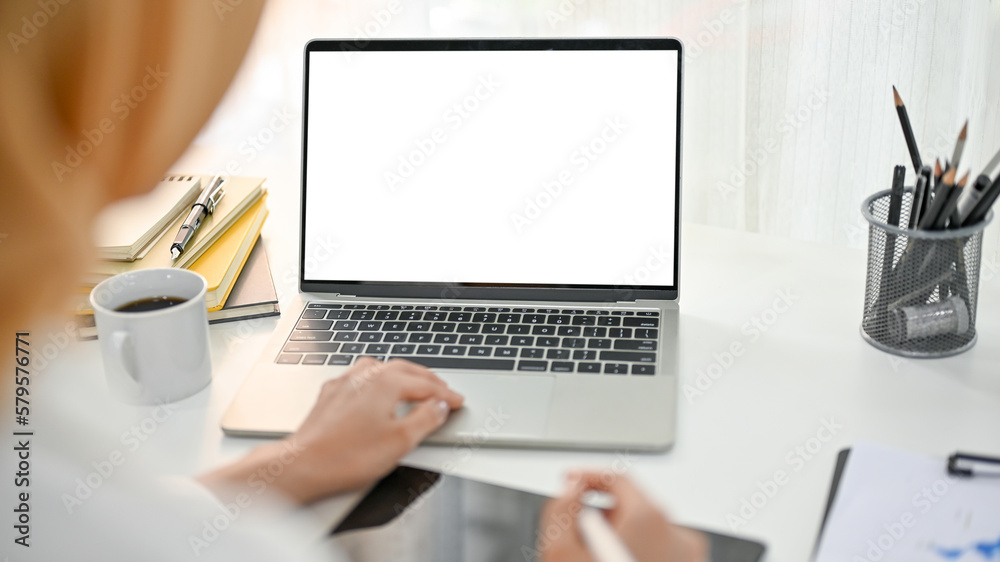 Close-up image of an Asian Muslim businesswoman working in her office, using laptop Close-up image of an Asian Muslim businesswoman working in her office, using laptop