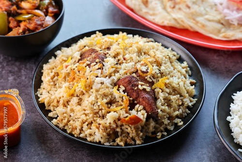 Chicken biryani Spicy Indian Malabar biryani Hyderabadi biryani. Dum Biriyani pulao Kerala India Sri Lanka Pakistan. Basmati rice mixed rice dish with meat curry Ramadan Kareem Eid