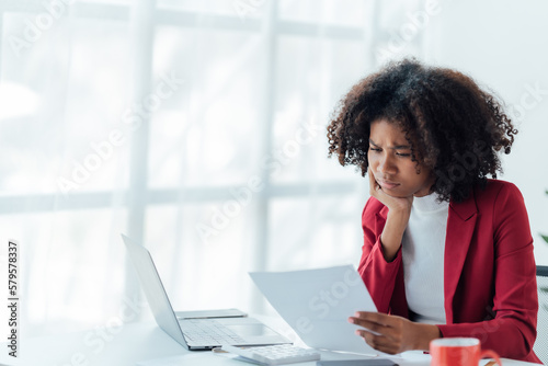 happy young businesswoman African American siting on the chiar cheerful demeanor raise holding coffee cup smiling looking laptop screen.Making opportunities female working successful in the office. 