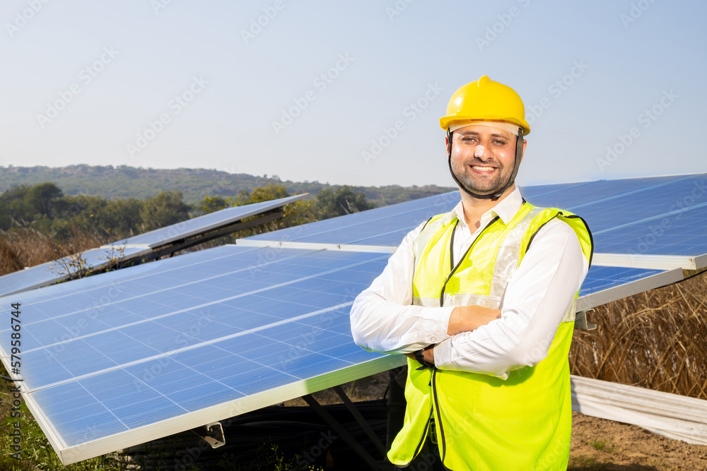 Portrait of Young indian man technician wearing yellow hard hat