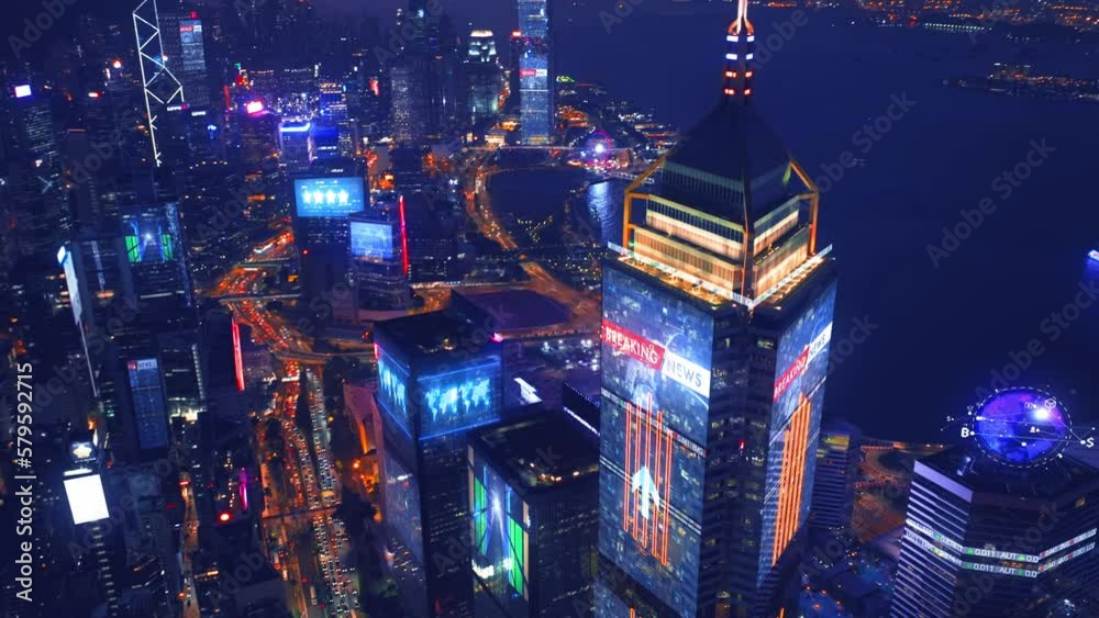 Aerial view of digital city with skyscraper and lighting advertising panels at night in Hong Kong City - Futuristic concept with motion graphic and digital animation - Information data communication