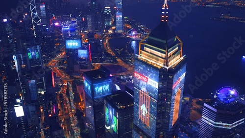 Aerial view of digital city with skyscraper and lighting advertising panels at night in Hong Kong City - Futuristic concept with motion graphic and digital animation - Information data communication photo