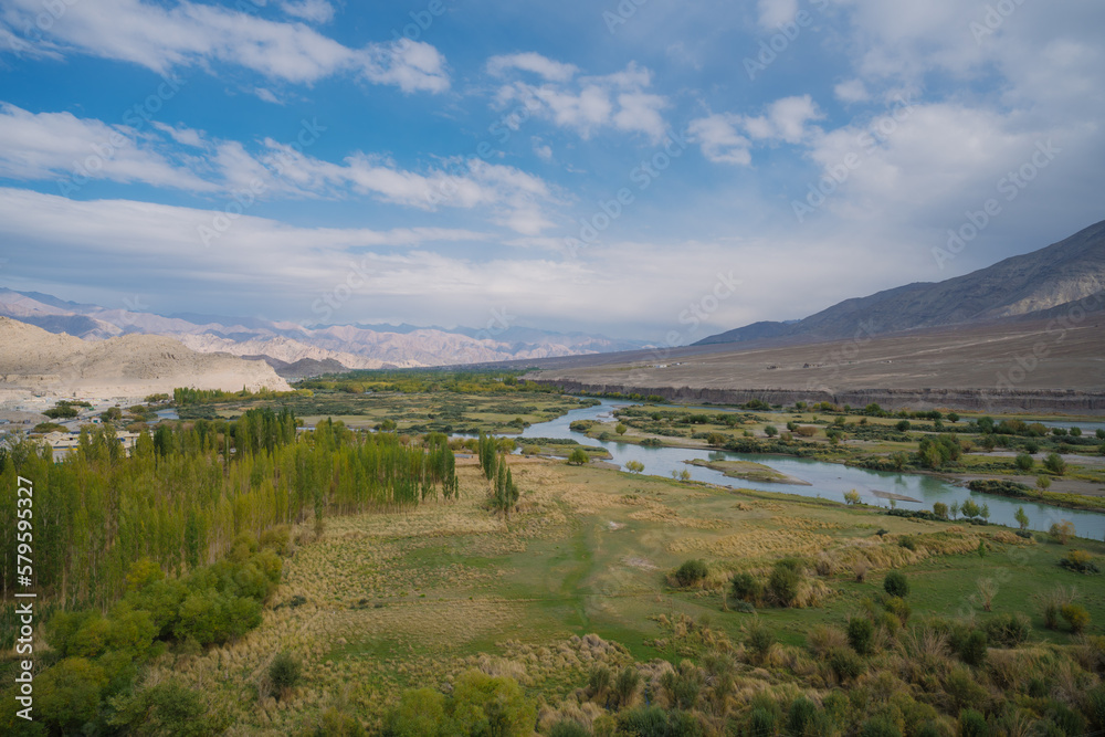 Beautiful landscape with greenery in a village, the background is surrounded by mountains at Leh town, Ladakh, in the Indian Himalayas. Beautiful landscape with greenery in a village, the background is surrounded by mountains at Leh town, Ladakh, in the Indian Himalayas.