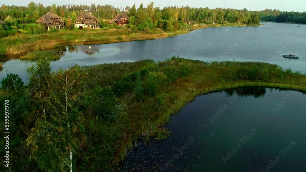 Vacation homes in the forest and on a beautiful lake in Latvia, aerial rise
