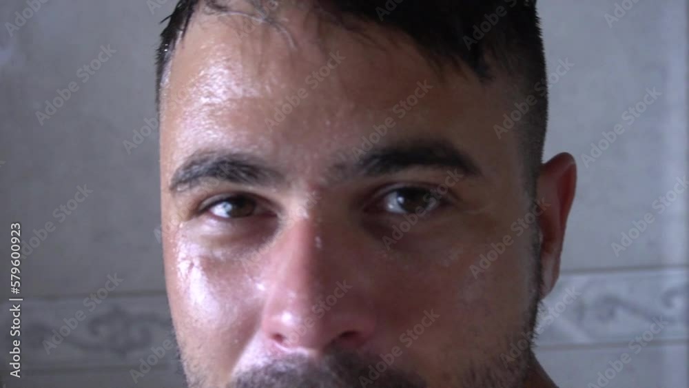 Happy man having fun on the shower during his facecare routine. He is worried about the coming of age and he is looking for good routines to keep his skin healthy Happy man having fun on the shower during his facecare routine. He is worried about the coming of age and he is looking for good routines to keep his skin healthy