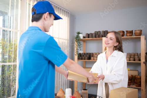 The delivery man brings the goods that the customer purchased and delivers them to the customer's home.