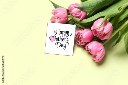 Greeting card with text HAPPY MOTHER'S DAY and beautiful tulip flowers on green background