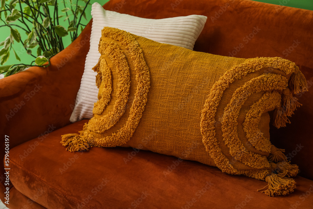 Soft cushions on cozy brown sofa, closeup